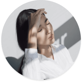 person covering forehead