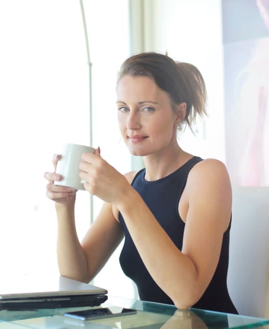 woman drinking from a mug
