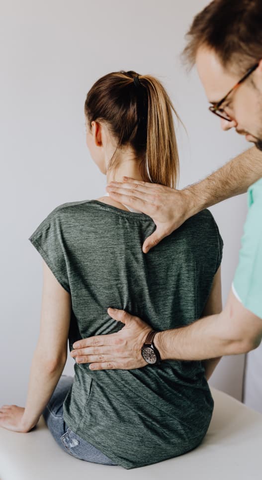 physical therapist adjusting patients back