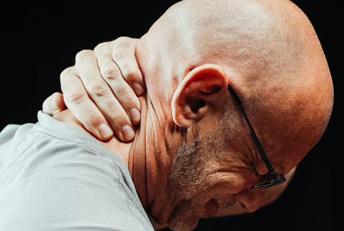 man holding neck
