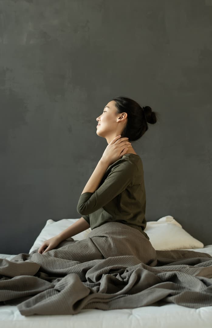 woman holding her neck