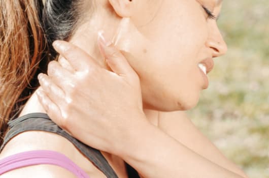 woman holding neck