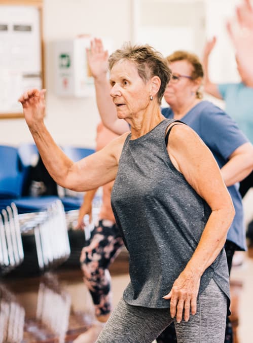 elderly woman at exercise class