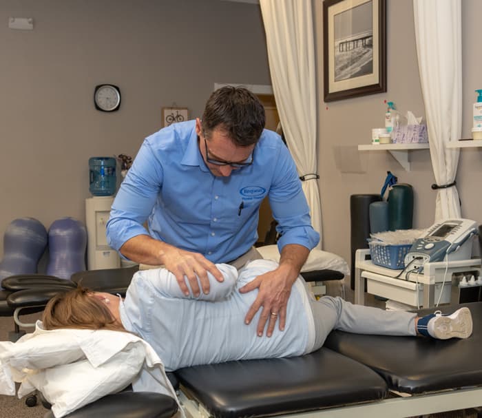 physical therapist working with patient