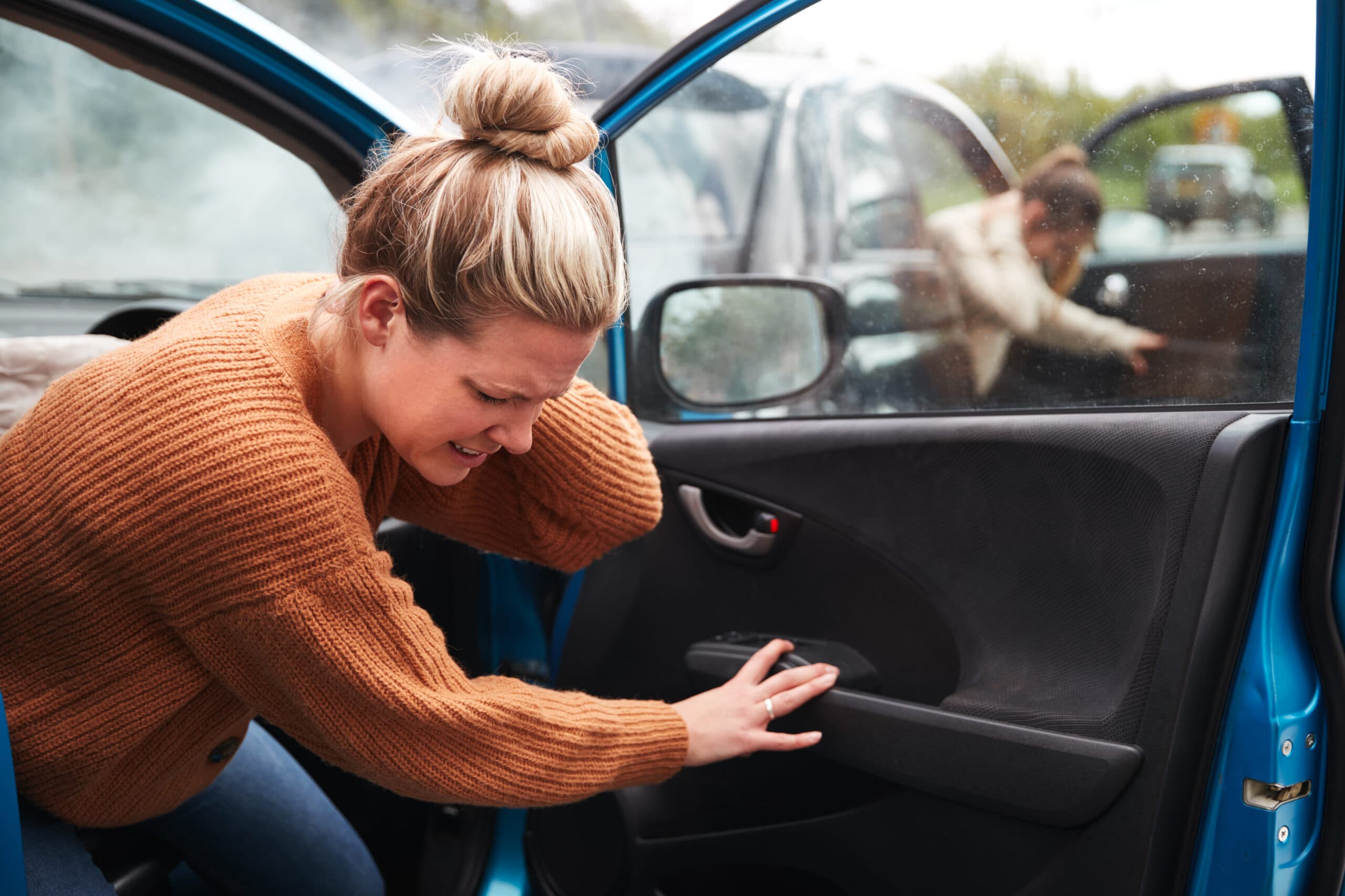 woman holding neck after car accident