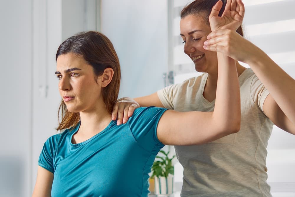 A physical therapist performing an adjustment