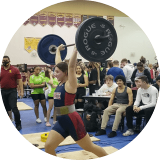 a girl lifting a big weight