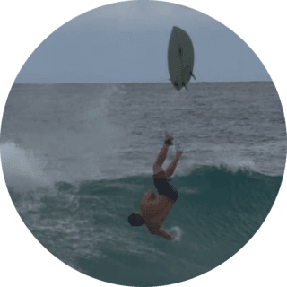 a guy on a surf board on a wave